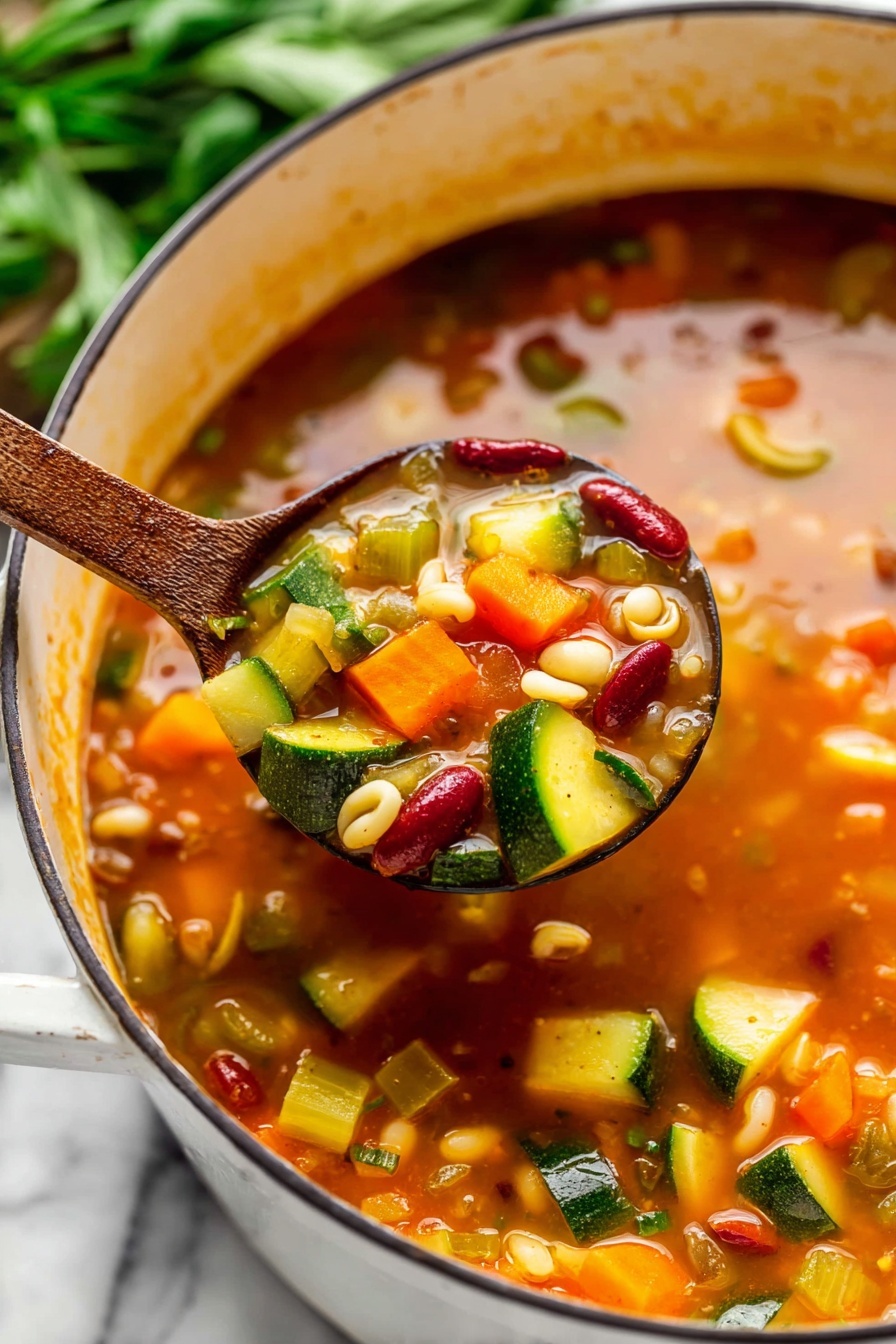 Minestrone Soup - A white pot filled with a thick stew showing layers of diced yellow and green zucchini, orange carrot pieces, red beans, chickpeas, shell pasta, and small red tomato chunks mixed in a rich orange-red broth with herbs, placed on a white marbled surface. A black spoon is inside the pot, and nearby are bunches of fresh green parsley, a gray and white striped cloth, and two silver spoons. Photo taken with an iphone --ar 2:3 --v 7