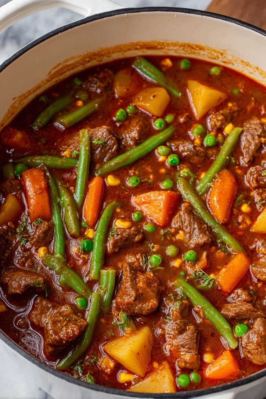 A white pot filled with thick brown stew, showing multiple layers of tender brown meat chunks scattered throughout. Bright orange carrot pieces, green peas, and long green beans float on top and inside the stew, along with small patches of yellow corn and cubed potatoes. The stew liquid is reddish-brown and slightly oily, coating all the ingredients with a rich texture. The pot rests on a white marbled surface. photo taken with an iphone --ar 2:3 --v 7