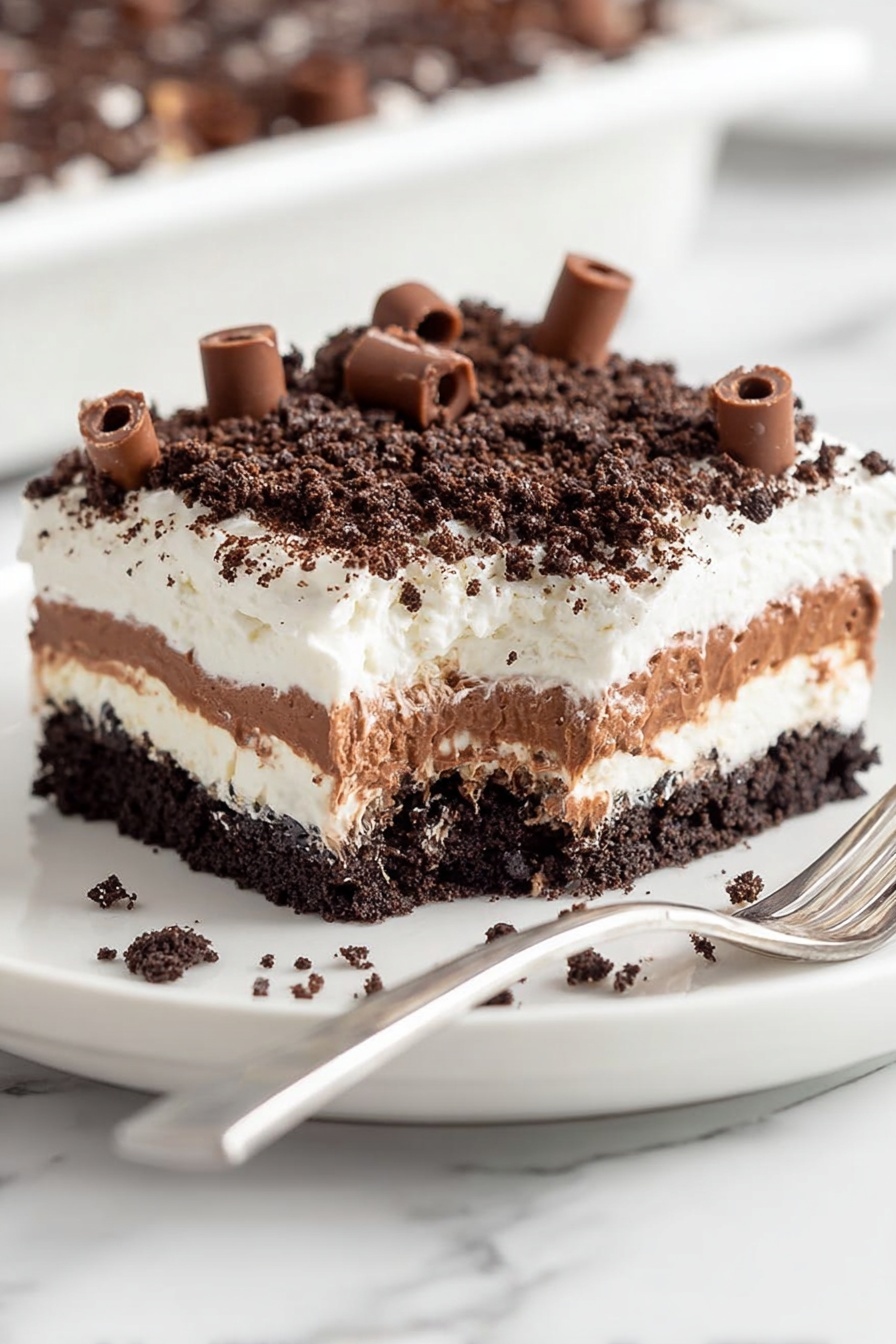 The image shows a square dessert with four layers on a white plate placed on a white marbled surface. The bottom layer is a dark crumbly crust that looks like crushed chocolate cookies. Above this is a thick, smooth white layer that appears creamy. On top of that is a thick light brown layer with a soft texture, looking like pudding or mousse. The next layer is a fluffy white cream that covers the whole top. The dessert is topped with small dark crumbs and many light brown chocolate curls scattered all over the top and around the plate. Photo taken with an iphone --ar 2:3 --v 7