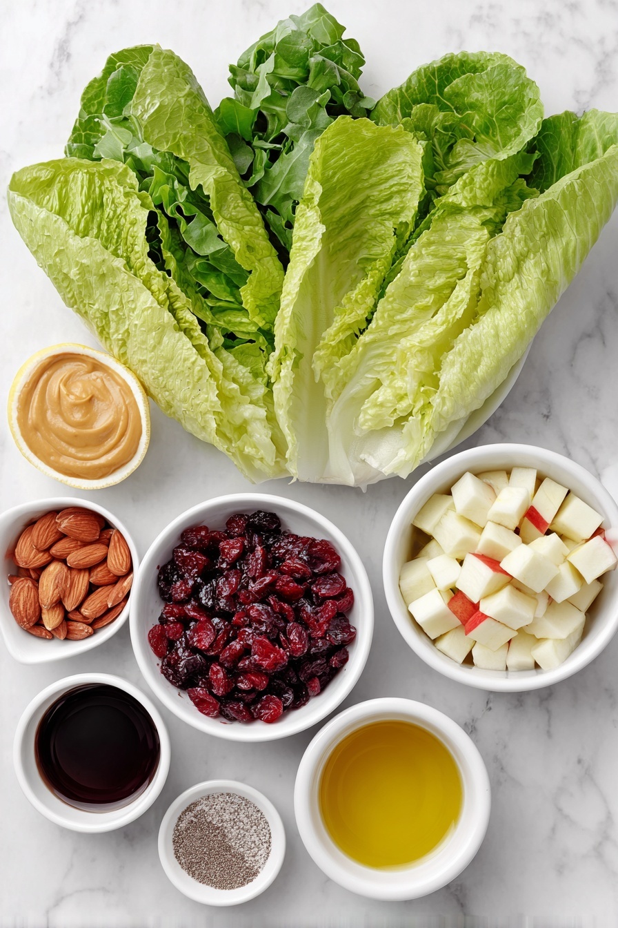 Flat lay of fresh large Romaine lettuce leaves, a small pile of vibrant baby rocket leaves, a handful of plump dried cranberries, crunchy candied almonds, a wedge of creamy blue cheese, neatly cubed fresh apple pieces, small white ceramic bowls holding smooth Dijon mustard, golden honey, deep red wine vinegar, bright lemon juice, coarse salt and black pepper, and a small white bowl filled with rich olive oil, all arranged in perfect symmetry on a clean white marble surface, soft natural light, photo taken with an iPhone, professional food photography style, fresh ingredients, white ceramic bowls, no bottles, no duplicates, no utensils, no packaging --ar 2:3 --v 7 --p m7354615311229779997