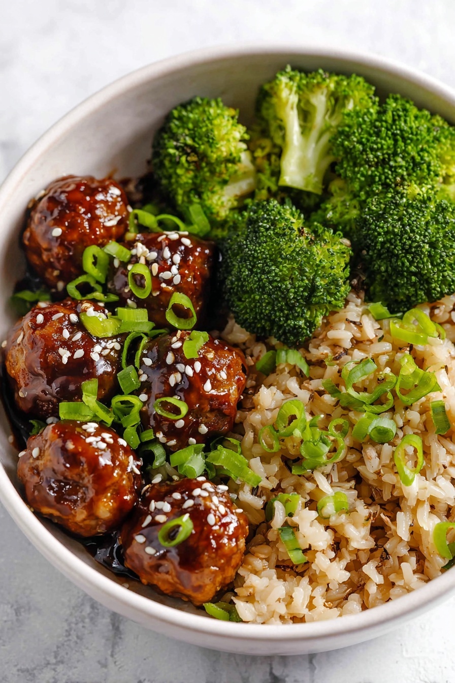A white bowl filled with three main parts: on the left side, a layer of glossy brown meatballs topped with green onion slices and white sesame seeds; on the right side, a pile of cooked brown rice mixed with some dark sauce and scattered green onion pieces; and at the back, a cluster of bright green broccoli florets. The bowl sits on a white marbled surface. photo taken with an iphone --ar 2:3 --v 7