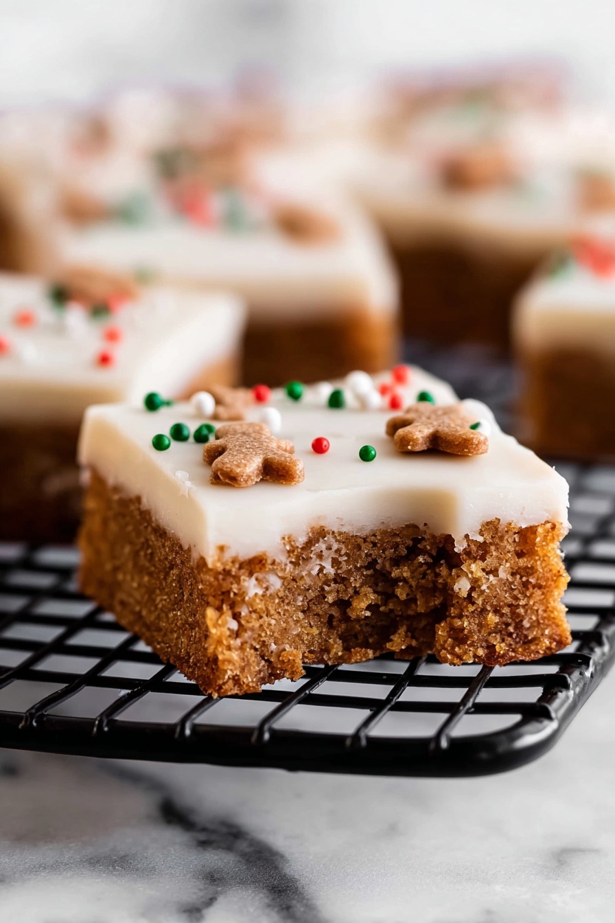 The image shows a close-up view of nine square pieces of a dessert arranged in a grid. Each piece has two visible layers: the bottom layer is a light brown, firm cake or biscuit base with a smooth texture, and the top layer is a thick, creamy white icing spread evenly across each square. The icing is decorated with small, round sprinkles in red, green, and white, and tiny gingerbread-shaped sprinkles scattered across the surface. The dessert is placed on a surface with a white marbled texture. The photo taken with an iphone --ar 2:3 --v 7