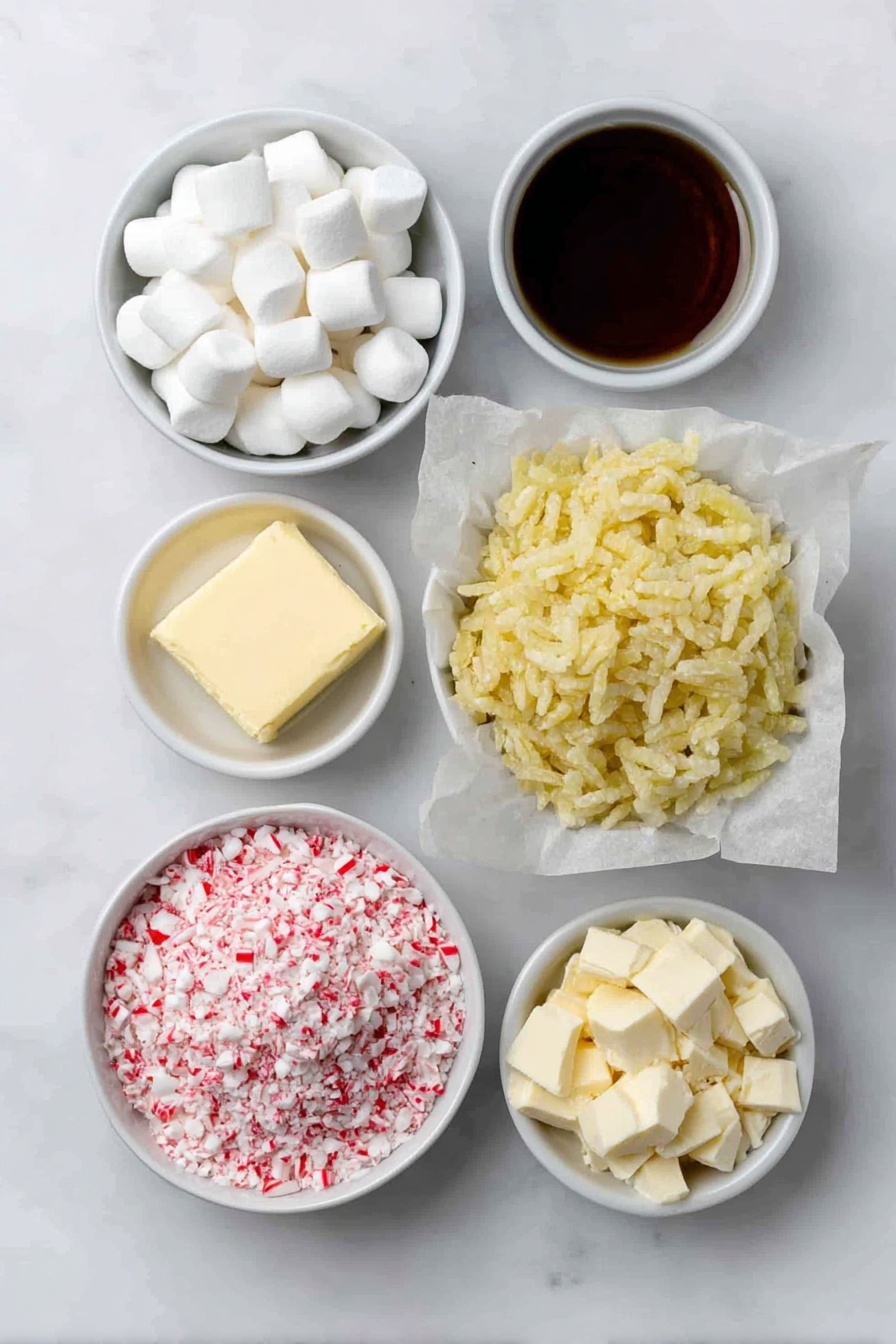 Flat lay of a half cup of salted butter block, two small piles of miniature white marshmallows, a small white bowl with clear peppermint extract, a large mound of golden puffed Rice Krispies cereal, a small white bowl filled with crushed red and white candy cane pieces, a simple white bowl with chopped dark chocolate chunks, and another white bowl with chopped white chocolate chunks, all arranged with perfect symmetry on a clean white marble surface, soft natural light, photo taken with an iPhone, professional food photography style, fresh ingredients, white ceramic bowls, no bottles, no duplicates, no utensils, no packaging --ar 2:3 --v 7 --p m7354615311229779997