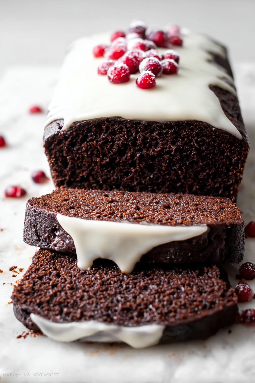 A dark brown chocolate loaf cake is shown sliced on a white marbled surface, revealing two thick layers of dense, moist cake. The cake is topped with a smooth, creamy white glaze that drips slightly down the sides and is decorated with a small cluster of bright red berries placed on top. The texture of the cake looks soft and rich with a slightly crumbly edge. Photo taken with an iphone --ar 2:3 --v 7