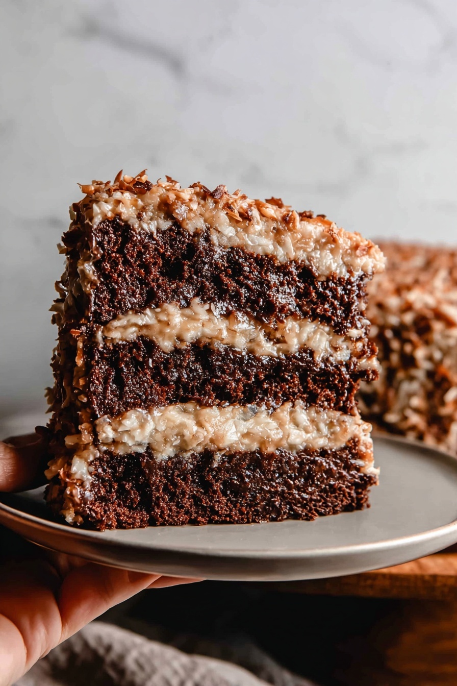 This image shows a three-layer chocolate cake with a light brown, creamy topping that has bits of coconut and nuts all over the top and between the layers. Each dark brown cake layer looks soft and thick, with the coconut and nut mixture spread evenly between them, oozing slightly at the edges. The cake is on a wooden board with a woman's hand holding a slice lifted slightly from the cake. The background is a white marbled texture. photo taken with an iphone --ar 2:3 --v 7