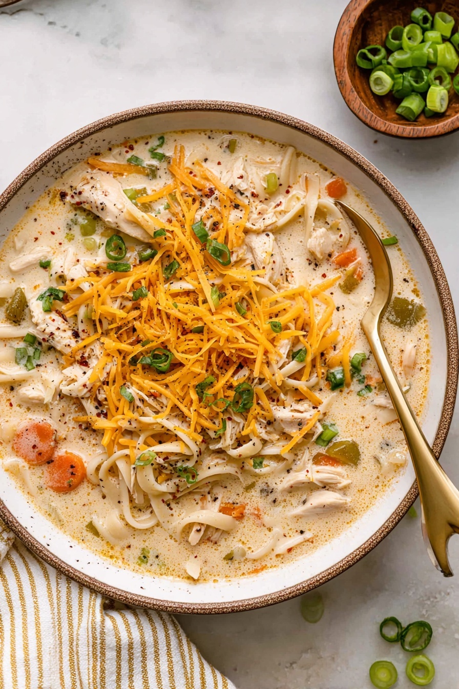 Inside a white pot, there are three layers of ingredients mixed together: bright orange carrot slices, light green celery pieces, and small white onion bits. On top of the vegetables, there is a small mound of minced garlic with a creamy texture. The inside walls of the pot show some browning from cooking. The pot is set on a stove with a black grill underneath. The photo taken with an iphone --ar 2:3 --v 7